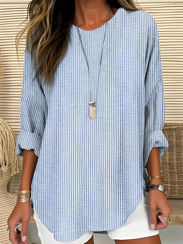 "Wanda™ | Płynna bluzka w paski" can be rewritten as "Wanda™ | Striped Fluid Blouse".